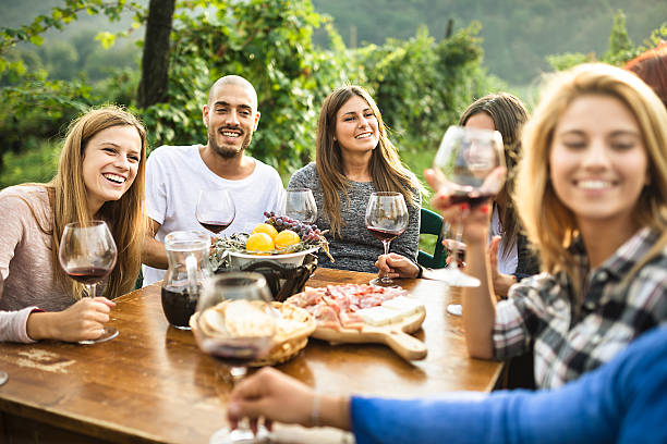 istock friends toasting with red wine after the harvesting 604015600