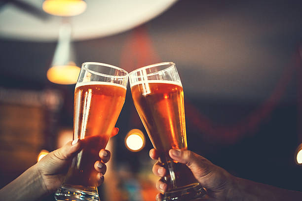istock Two friends with glasses of beer. Shallow DOF 604016418