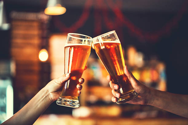 Two friends with glasses of beer. Shallow DOF stock photo