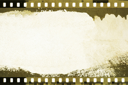 Close up of the end of a 35mm color negative photographic film, with a light-leak close to the end frame.