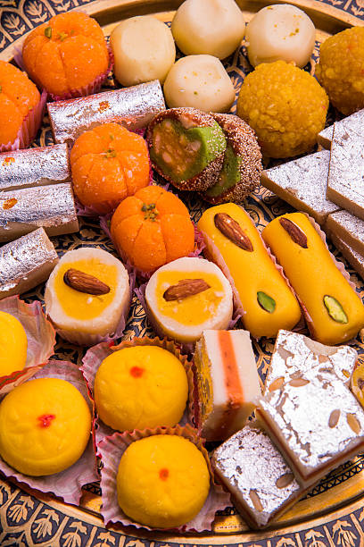 variety of delicious diwali sweets from india indian sweet food consumed in festivals like diwali, holi, dussehra, gudhi padwa or weddings india sweets stock pictures, royalty-free photos & images