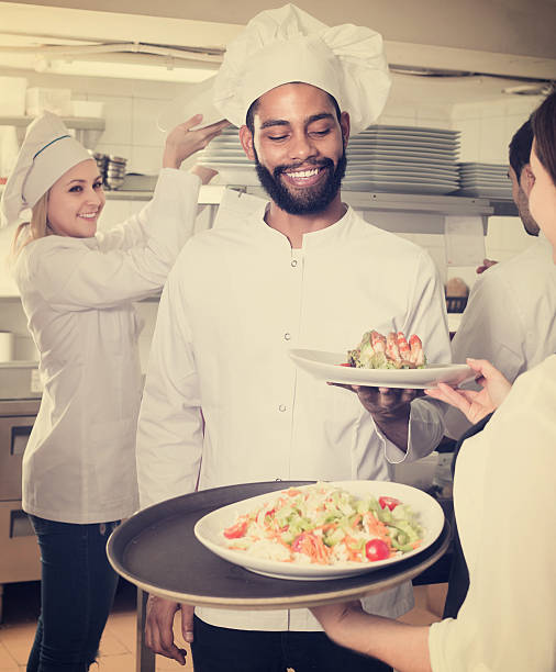 istock Waitress and cooking team in restaurant 604018362