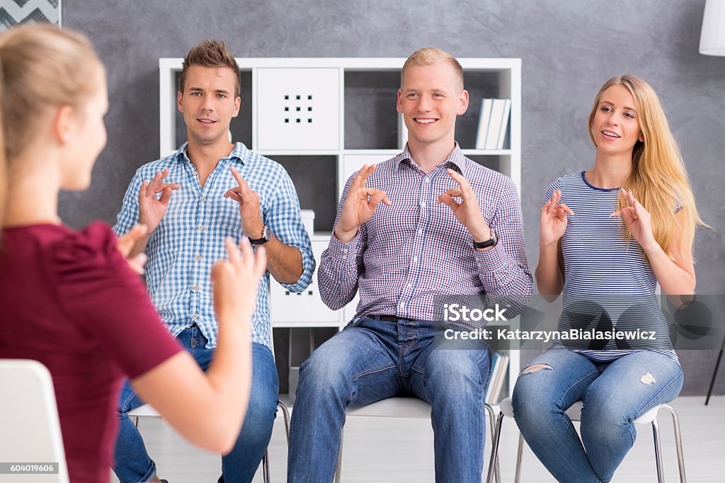 Beautiful langauge is a sign language Group of young people learning a sign language Sign Language Stock Photo