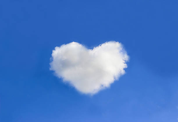 istock Cloud with heart shapes on blue sky background 604019862
