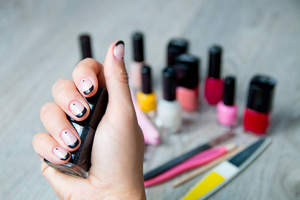 istock Black nail polish being applied with tools for manicure 604020438