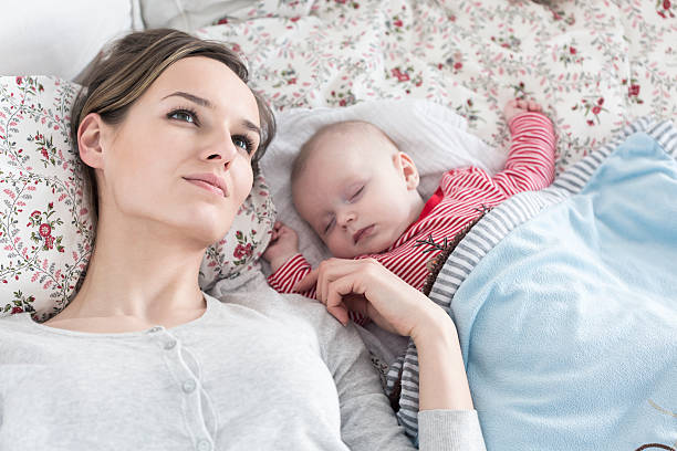 istock Mother and baby taking nap together 604020886