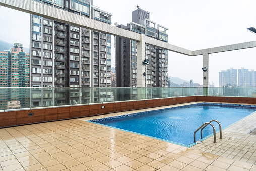 hotel top swimming pool with residential apartments background,hong kong,china.