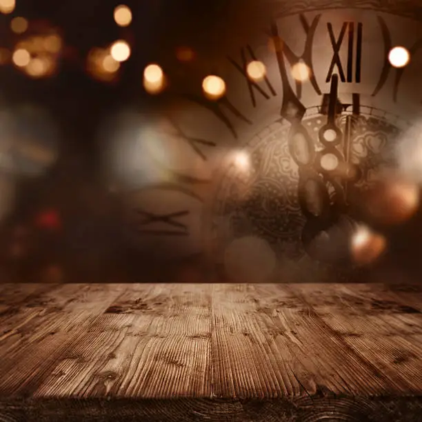 New year background with a clock in front of a table