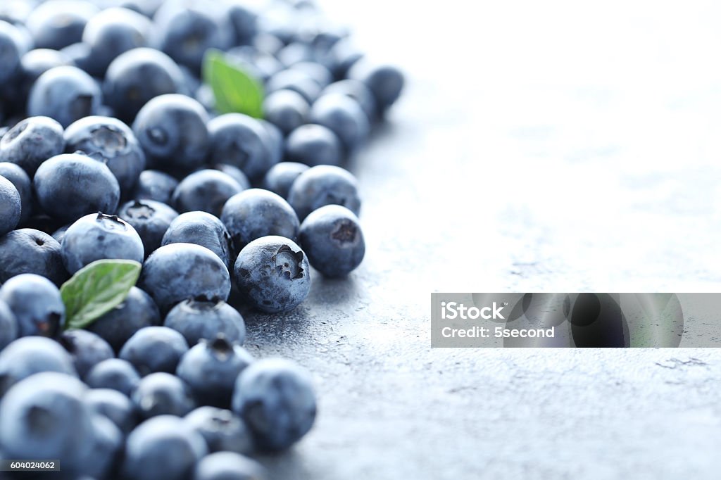 Ripe and tasty blueberries on grey wooden table Antioxidant Stock Photo