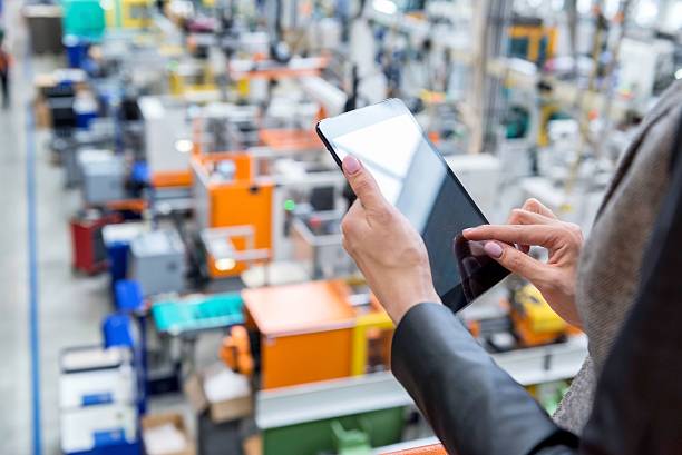 istock Digital tablet & Futuristic factory 604025766