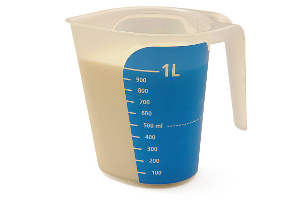 Measuring cup 1 litre milk 1 litre milk, isolated on white, with clipping path milliliter stock pictures, royalty-free photos & images