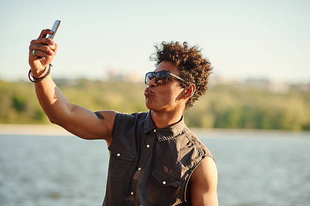 istock Handsome man making selfie and grimacing with opened mouth 604027674