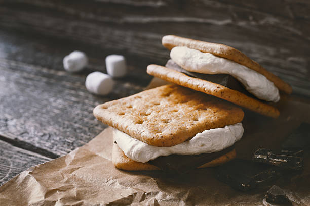 Smores on the parchment  on the  wooden table Smores  on the parchment on the wooden table horizontal smore photos stock pictures, royalty-free photos & images