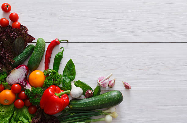 istock Fresh vegetables border on white wood background with copy space 604029176