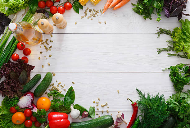 istock Fresh vegetables border on white wood background with copy space 604029740
