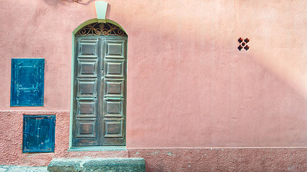 istock old door on pink wall with copy space 604030904