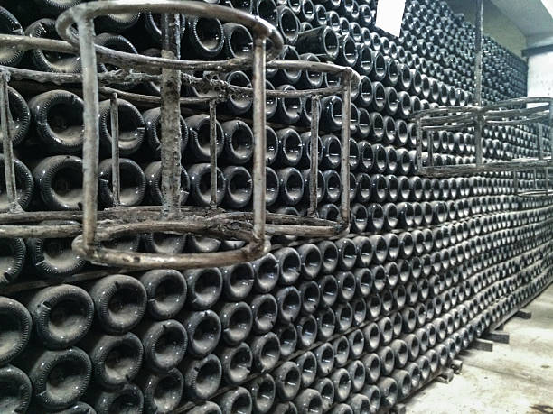 istock Collection sparkling wines aging in the rack in winery cellar 604030956