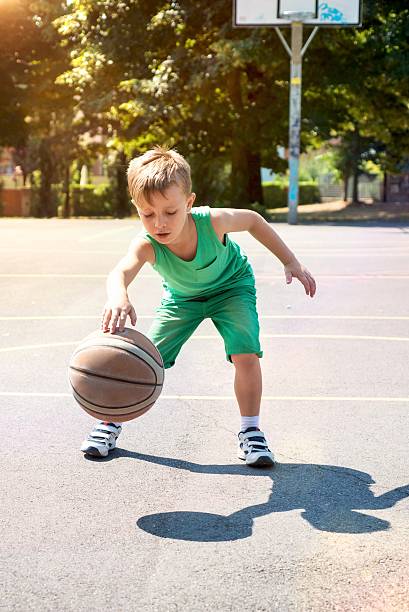 istock Child Playng Basketball 604030998