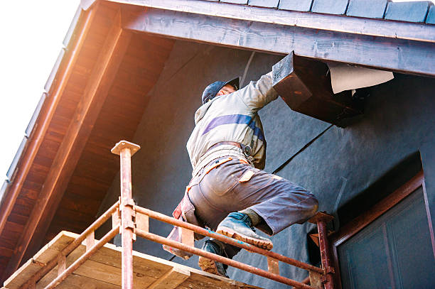 istock Construction worker thermally insulating house with glass wool a 604032080