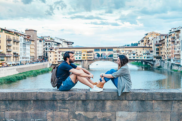 istock Couple at sunset in front of Ponte Vecchio Florence 604032760