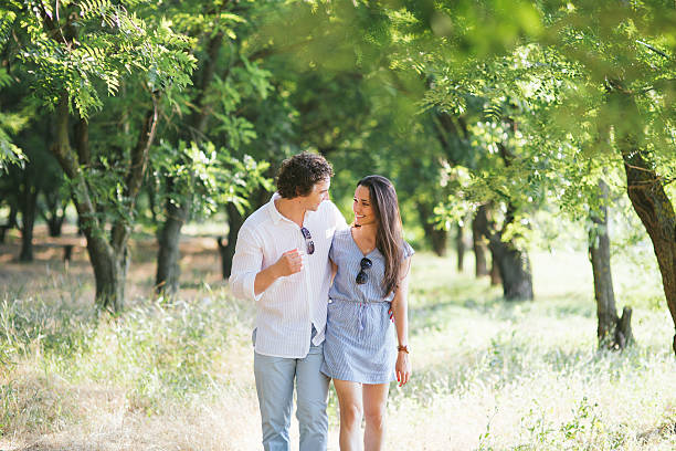Young happy couple walking in the summer nature.