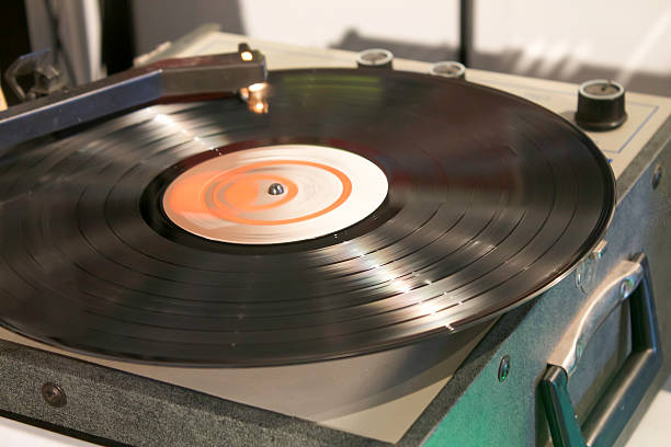 istock Vintage Turntable Spinning Vinyl Record Close-Up 604036760
