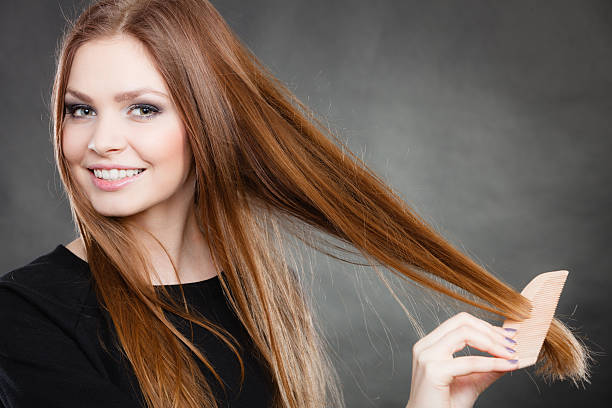 Long haired girl combing her beauty hair. Preparation to evening party. Gorgeous attractive woman combing her long straight smoothy healthy hair before go out. Party and celebration concept. human hair women brushing beauty stock pictures, royalty-free photos & images