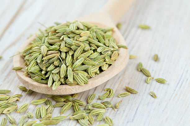 istock fennel seed in a wooden spoon on table 604055638