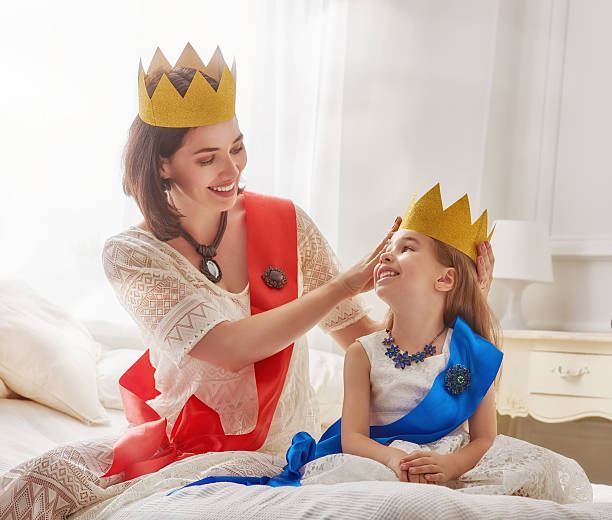 istock queen and princess in gold crowns 604333714
