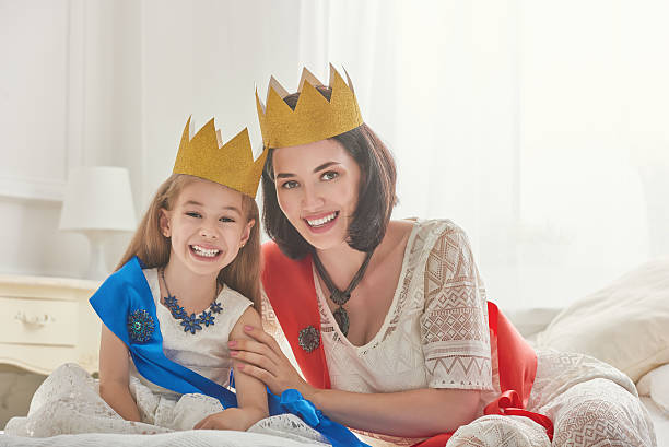 istock queen and princess in gold crowns 604333796