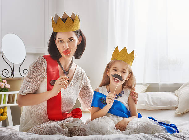 istock queen and princess in gold crowns 604334048