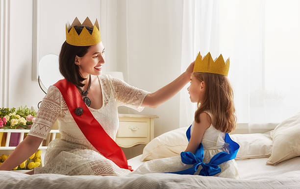 istock queen and princess in gold crowns 604334184