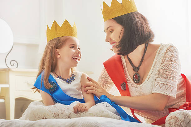 istock queen and princess in gold crowns 604334292