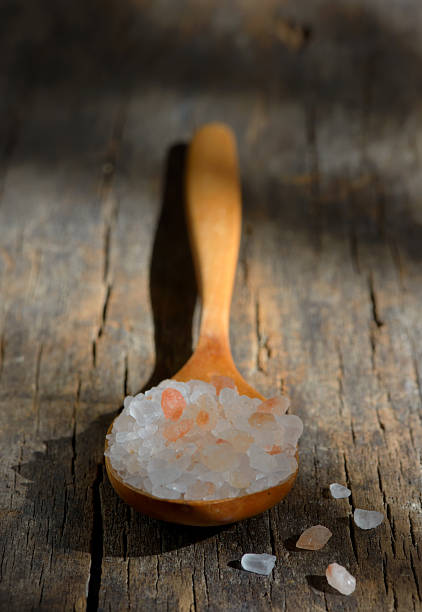 istock Pink himalayan salt on wooden table 604334666
