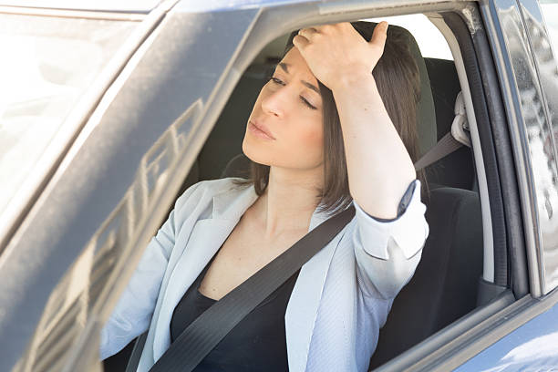istock Unhappy woman driving her car 604335176