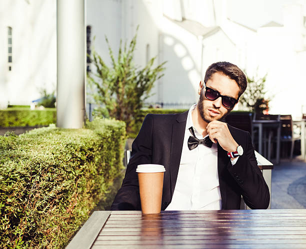 istock Coffee break. Man business man in a business suit 604335702