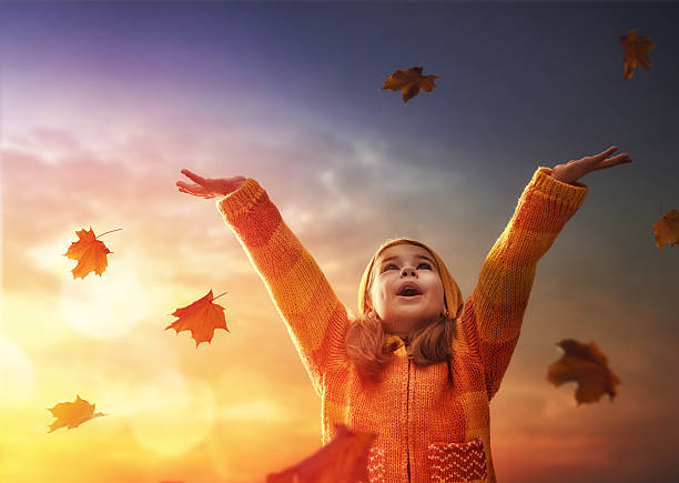 istock child playing in the autumn 604335792