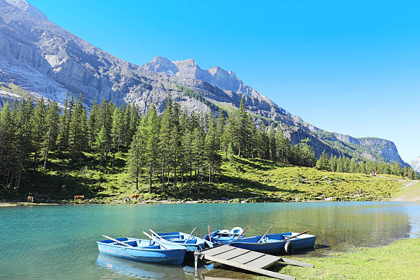 Rental Boats at Oeschinensee Lake in Switzerland Empty rowboats at Oeschinensee lake in the morning. Oeschinen Lake is an amazing hiking destination and a UNESCO World Heritage Site in Berner Overland region in central Switzerland. lake oeschinensee stock pictures, royalty-free photos & images
