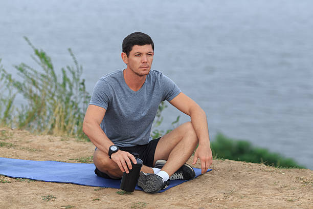 istock The young athlete is tired and sits. 604338346