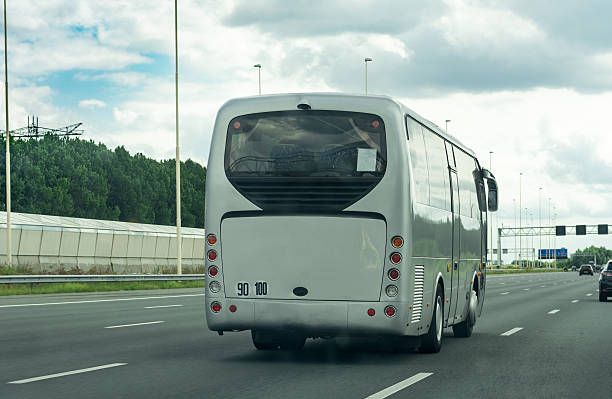 istock Grey bus traveling on empty highway in europa 604338464