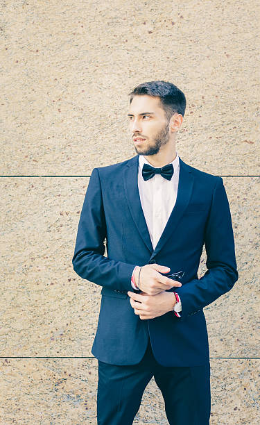 istock Portrait. Young businessman in a suit and bow tie 604338562
