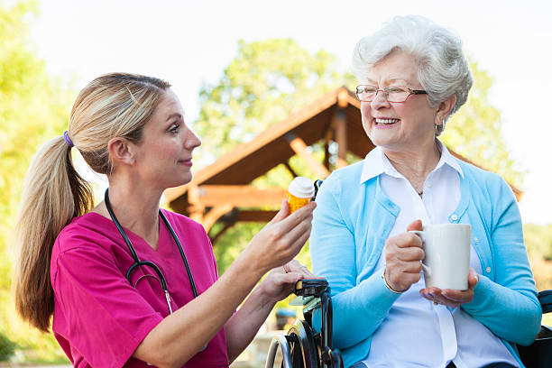 istock Beautiful nurse explains medication to senior patient 604338682