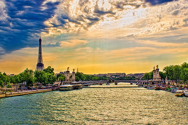 The Eiffel Tower is a wrought iron lattice tower on the Champ de Mars in Paris, France. It is named after the engineer Gustave Eiffel, whose company designed and built the tower. Constructed in 1889 as the entrance to the 1889 World's Fair, it was initially criticized by some of France's leading artists and intellectuals for its design, but it has become a global cultural icon of France and one of the most recognisable structures in the world. Horizontal composition. Image developed from RAW format.