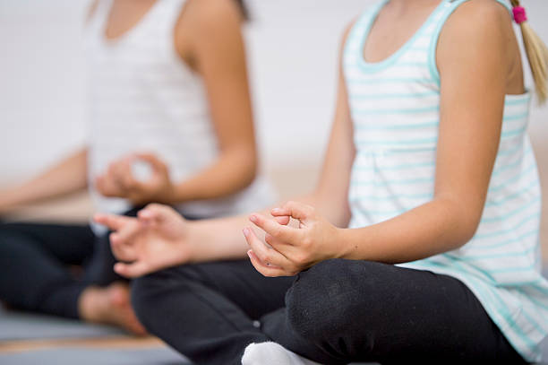 istock Two Girls Doing Yoga 604339074