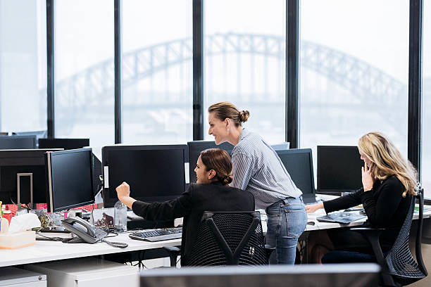 Professional businesswomen in Australian office working on computers