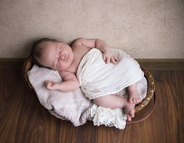 istock One month old baby in the basket 604340802
