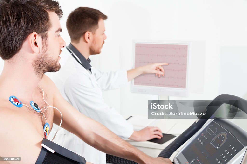 cardiac stress test ECG tracings Doctor shows the patient the ECG recording of the electrical activity of the heart Emotional Stress Stock Photo