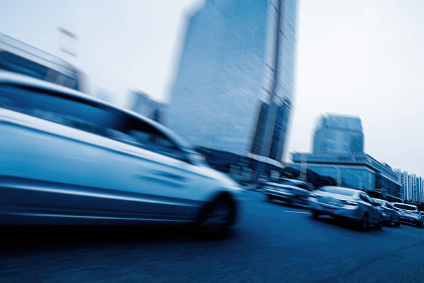 istock City road with moving car 604343132