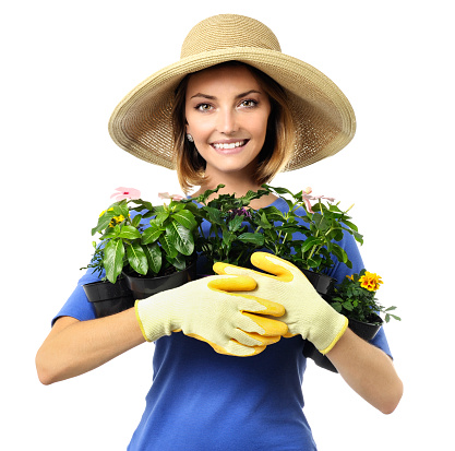 Woman gardener with potted plants on white