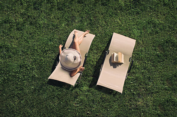 istock woman lying on a sunbed 604343450